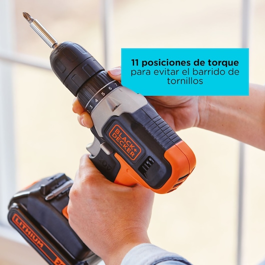 Close-up of BLACKDECKER cordless drill BCKSB29C02 with orange and black grip, showing torque adjustment dial.