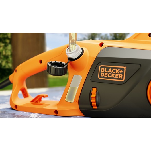 Close-up of BLACK+DECKER BECS2040 chainsaw showing oil filling port, cap, and side controls.
