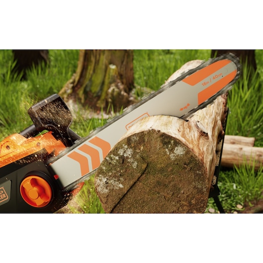 BLACK+DECKER BECS2040 chainsaw cutting a log outdoors, close-up view with orange accents and visible sawdust.